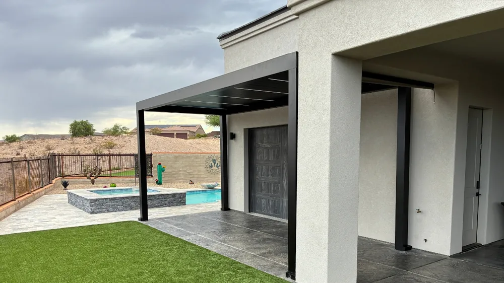 Attached Atlas louvered pergola in Onyx over a poolside patio in Bullhead City NV