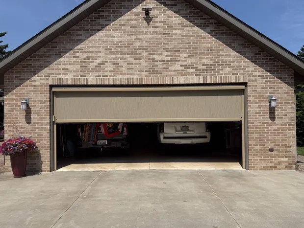 Motorized garage screen with 95% nano fabric over a two-car garage opening