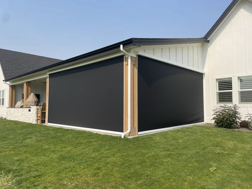 Motorized privacy screens on a covered patio corner