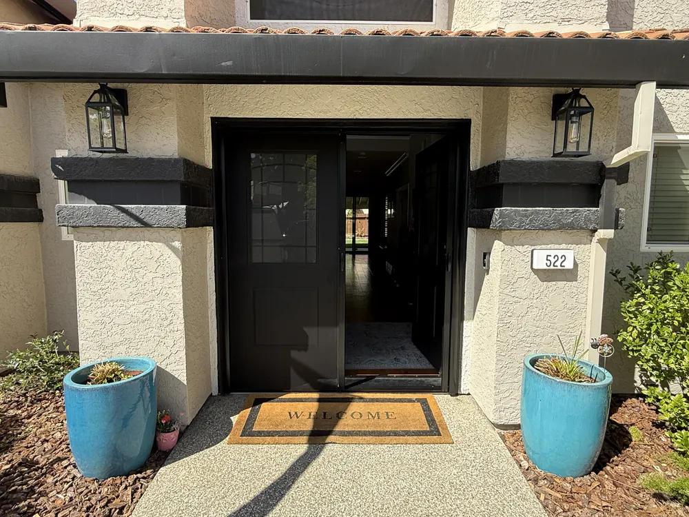 Black retractable screen extended across a glass double front door in Folsom, CA