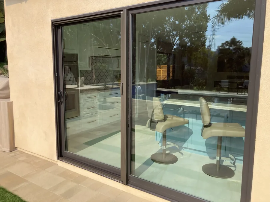 Bronze Apollo retractable sliding screen door on a tall patio door